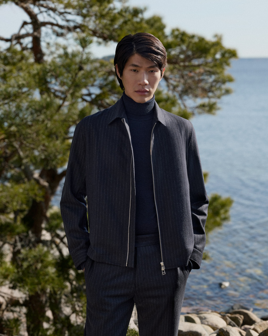 Man in navy pinstriped set